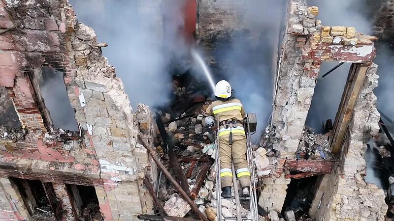 Rettungskr&auml;fte versuchen nach einem Angriff auf die Stadt Mykolajiw einen Brand zu l&ouml;schen.