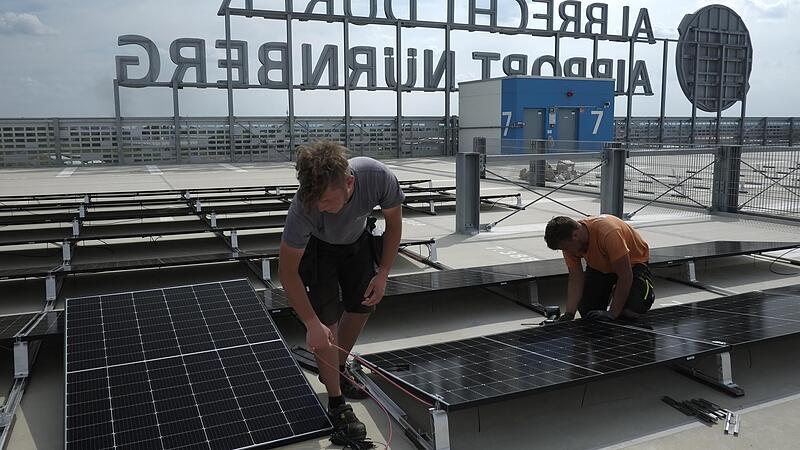 Auf dem Dach des neuen Parkhauses werden Solarmodule montiert.
