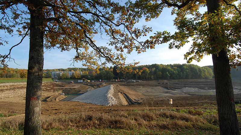 Die Grundsperre in der linken Bildh&auml;lfte ist ein Wall aus Steinen &ndash; ein Damm vor dem Damm, der k&uuml;nftig unter dem Wasser verschwinden wird.